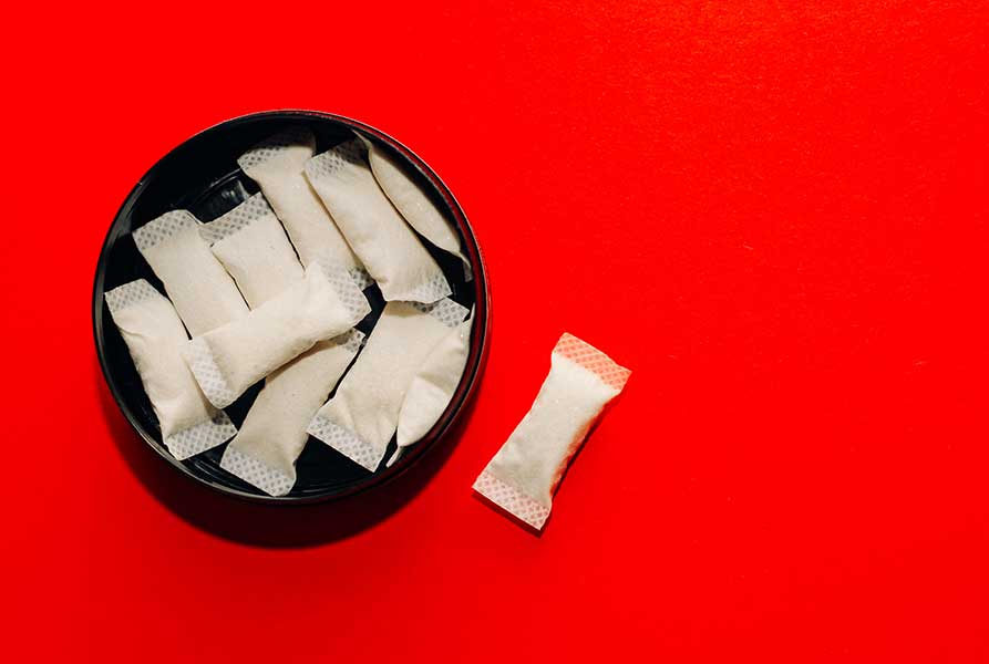 Nicotine Pouch Can on a Red Background